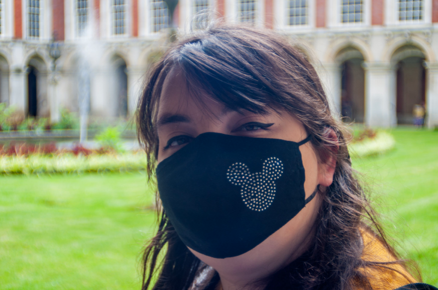 Ciara wearing a black face mask with Mickey Mouse on outside Hampton court